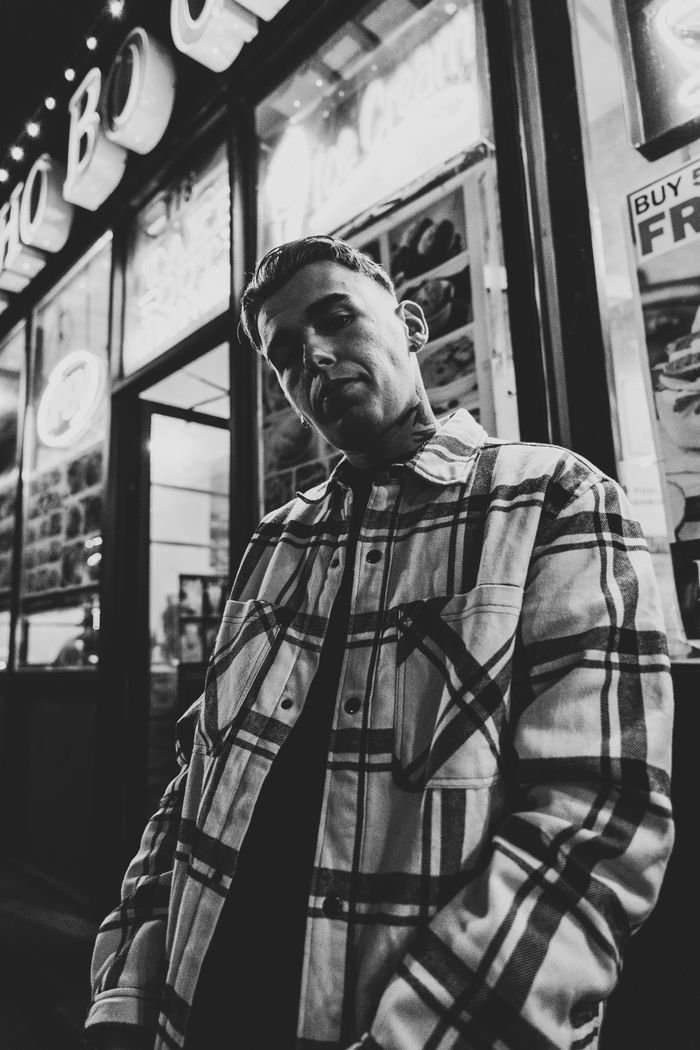 collection-01 Black and white portrait of a man in a plaid shirt at night in Ottawa, Canada.