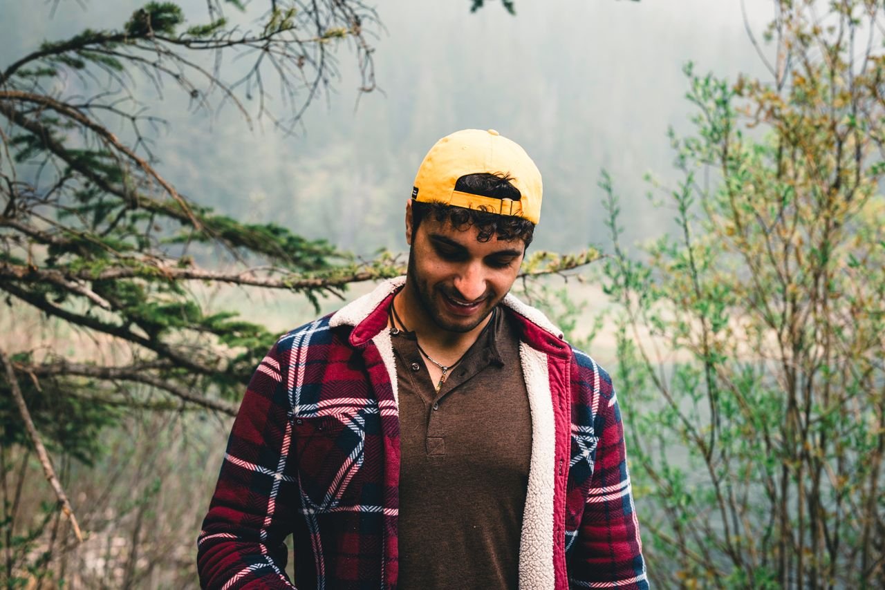 Crafting Captivating Headlines: Your awesome post title goes here A young man in a plaid shirt enjoys the serene nature of Banff National Park, Canada.